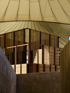 Modern interior design featuring a wooden structure and a tent-like roof.