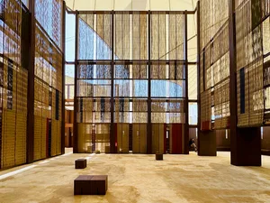 A spacious, modern library with textile partitions and wooden flooring.