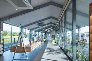 A modern retail store featuring glass and steel interiors with a minimalist design
