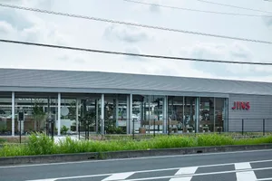 Modern glass and concrete storefront of a retail shop.