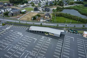 Parking lot with a large concrete sculpture.