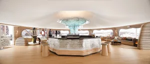 A modern coffee shop interior featuring a glass counter and barista station.