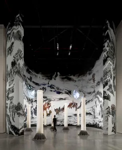 A modern installation art piece featuring mixed media materials and a dramatic, immersive space.