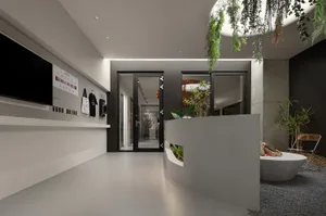 Modern office space with concrete walls, glass doors, and green foliage planters.