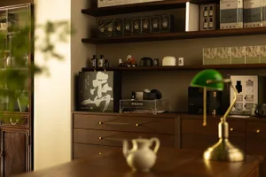 A cozy, contemporary modern office space features wood, glass, and metal elements.