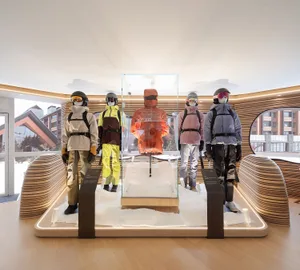 A modern product display featuring glass, wood, and a simulated snow environment