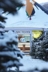 A retail storefront with snow-covered walls and roof