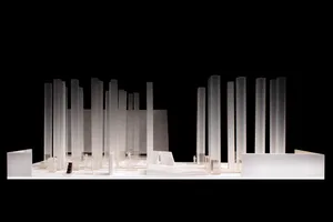 A model of a modern architectural design featuring tall columns made of glass, metal, and concrete materials.