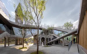 Large, modern building with concrete, glass, and wooden elements