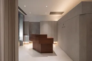 A modern office reception desk made of metal and wood.
