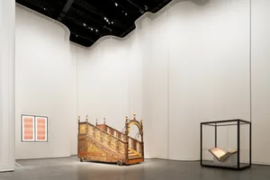 An exhibition in a gallery showcasing a large, ornate architectural structure