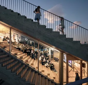 People attending an event in a modern industrial space with concrete and wooden stairs.