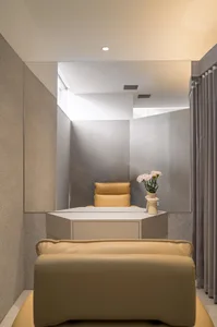 A minimalist office space featuring concrete and leather materials.