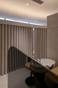 Modern bathroom featuring marble sink and contemporary curtains