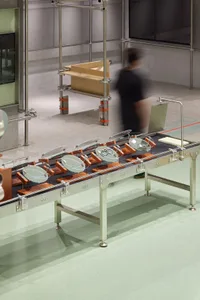 A modern industrial manufacturing line featuring metal and wood materials.