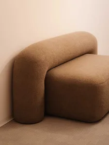 Modern sofa in a living room setting, upholstered in a beige fabric.
