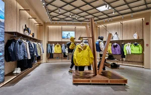 A modern clothing store showcasing a variety of colorful jackets hanging from racks and displayed on mannequins.