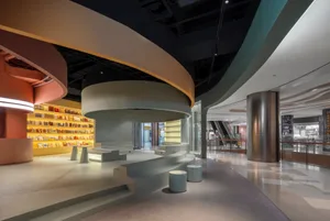 A modern office interior with concrete walls and glass partitions.