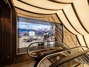 Modern retail shop interior with a large display advertising a Kolon Sport product.