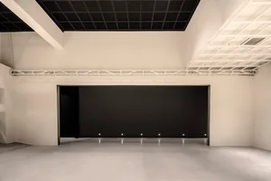Minimalist office space featuring concrete and metal materials.