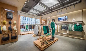 A retail clothing store showcasing various garments and accessories arranged on shelves and racks.