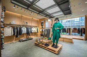 A modern retail store interior featuring a mix of wood, glass, and metallic elements.
