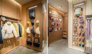 A retail store displaying various accessories, including bags, hats, and clothing, arranged on wooden panels.