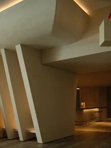 Modern, minimalist bar area featuring concrete architecture and lighting.