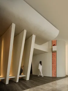 A modern interior space featuring concrete walls and black marble flooring.