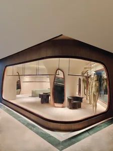 Modern retail shop interior with concrete finishes, minimalist design, and furniture.