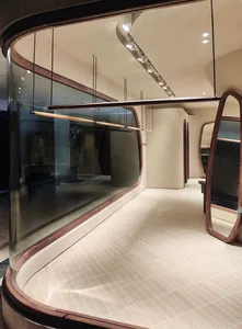 Modern retail storefront featuring glass walls and concrete flooring.