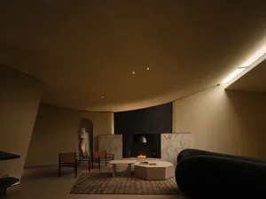 A modern living room with concrete and marble elements.