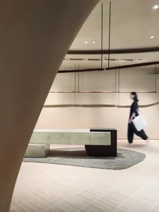 A modern lobby featuring concrete materials and a sleek, minimalist design.
