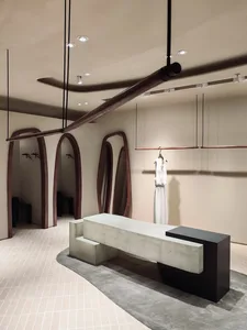 Modern retail store interior featuring concrete walls and minimalist design.