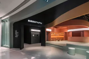 Modern cinema reception area featuring concrete and steel materials.