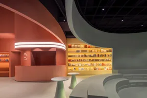 A modern bookstore with concrete design elements and a bright, inviting atmosphere.