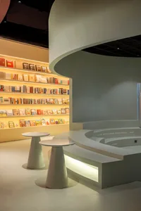 A modern bookstore with round counters and curved bookshelves.