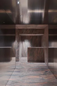 A modern office interior with granite walls and marble flooring.