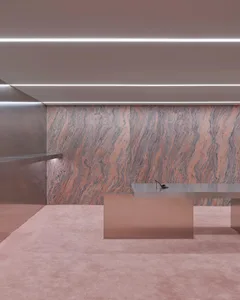 Modern office space with marble table and sleek design elements.