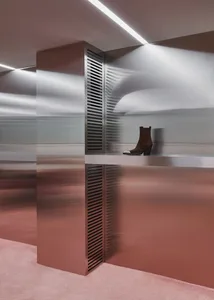 Modern retail storefront featuring metallic materials and minimalist design elements.