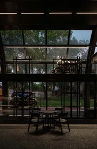 Industrial-style cafe interior featuring metal detailing and tables.