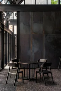 A modern industrial café with metal table and chairs.