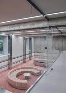 Modern office with industrial design elements, featuring steel and glass materials.