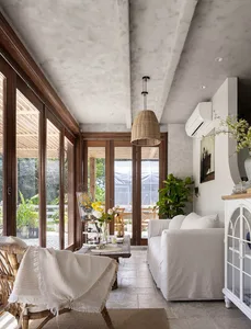 A minimalist living room with wooden furniture, white accents, and a cozy atmosphere.