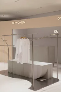 Minimalist retail store with metallic and concrete accents