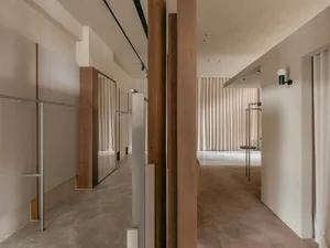Modern minimalist storefront with wood, fabric, and glass elements