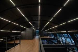 A modern industrial office space with metal and glass elements.