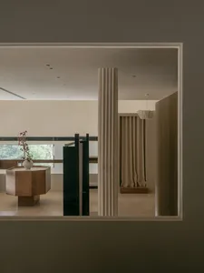 A modern interior space featuring a concrete column and minimalistic design elements.