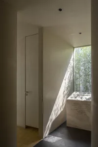 A modern interior space featuring concrete and glass materials.