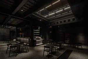 Industrial-themed restaurant interior with metallic finishes and dark color palette.